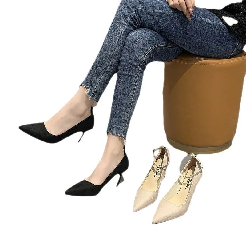 Women's black stiletto heel pump shoe with a silver buckle detail on the front.
