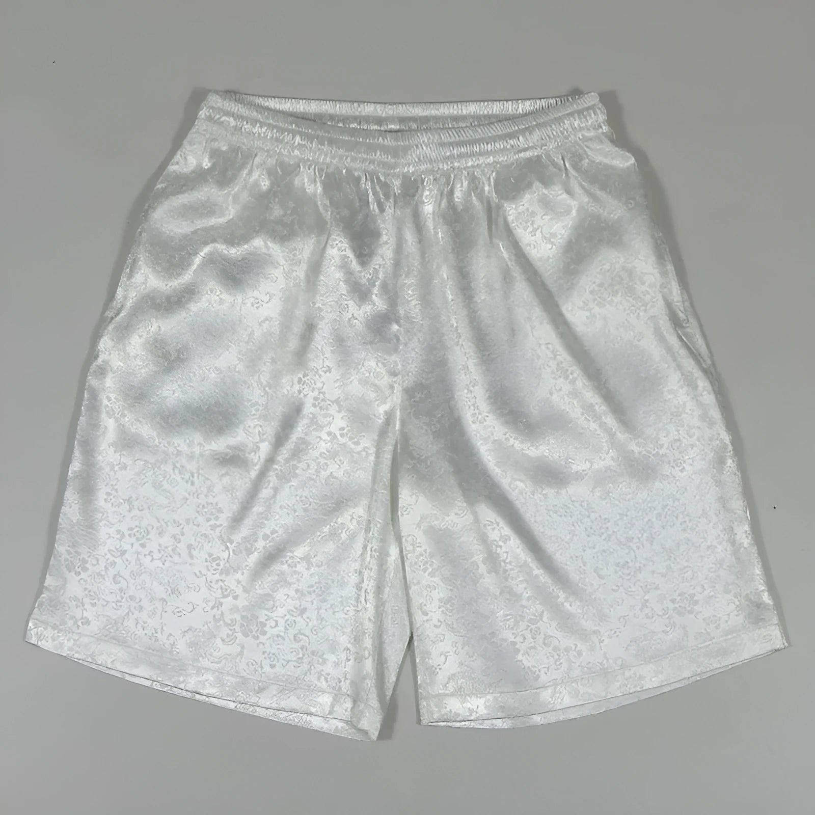 Men's black loose-fit Tang suit Tai Chi shorts with a drawstring elastic waistband on a white background.