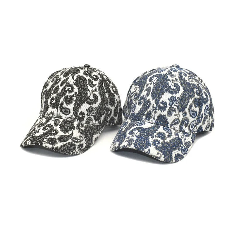 Blue polyester baseball cap with a white paisley pattern, showing the dome crown style.