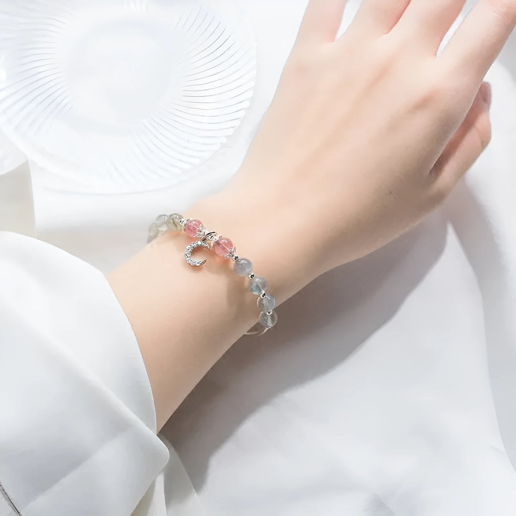 Natural moonstone handmade bracelet with crescent moon charm on wrist showing adjustable clasp