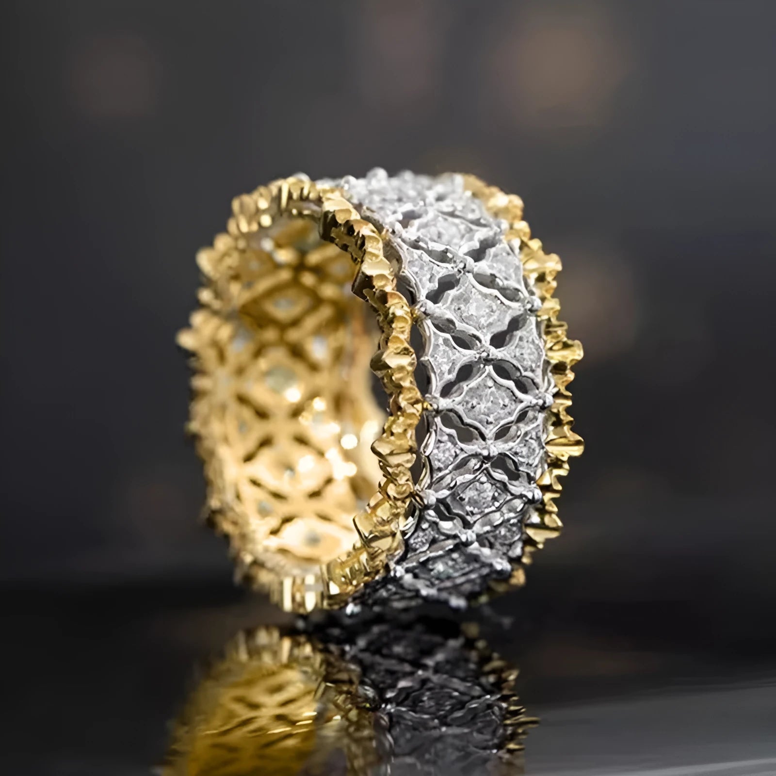Geometric gold two-tone zircon ring on a copper band, showing round detail.