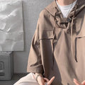 Man modelling a loose grey hooded short sleeve t-shirt, showing the pullover style and front design.