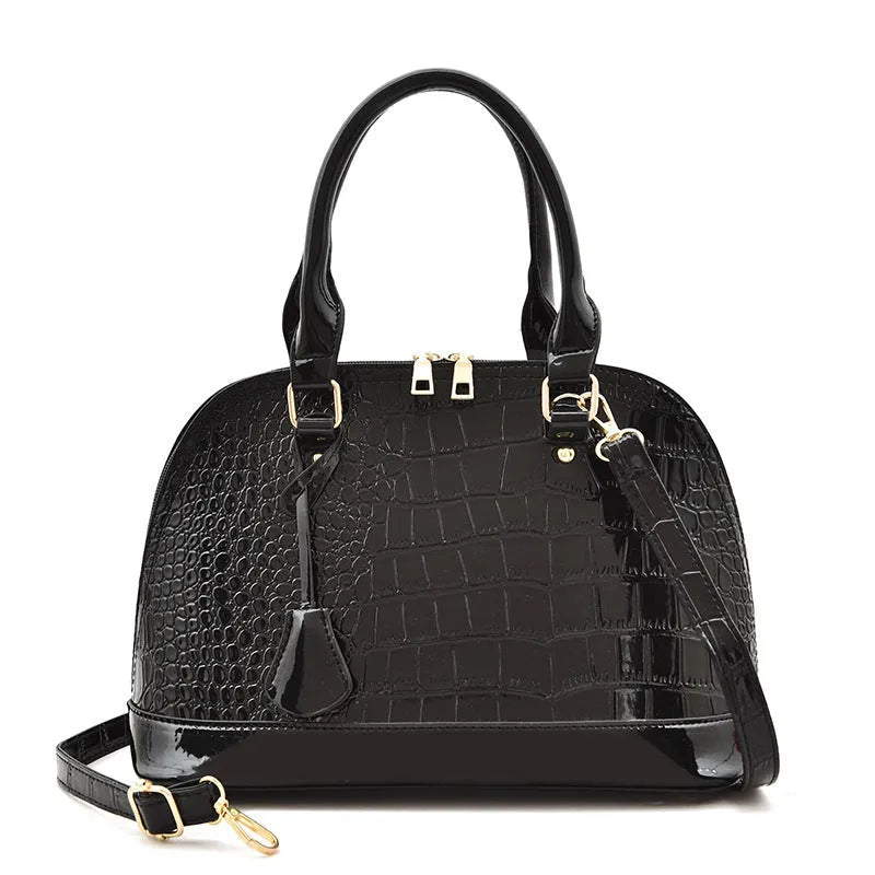 Shiny PU leather crossbody shoulder bag in structured shell shape design showing black colour option