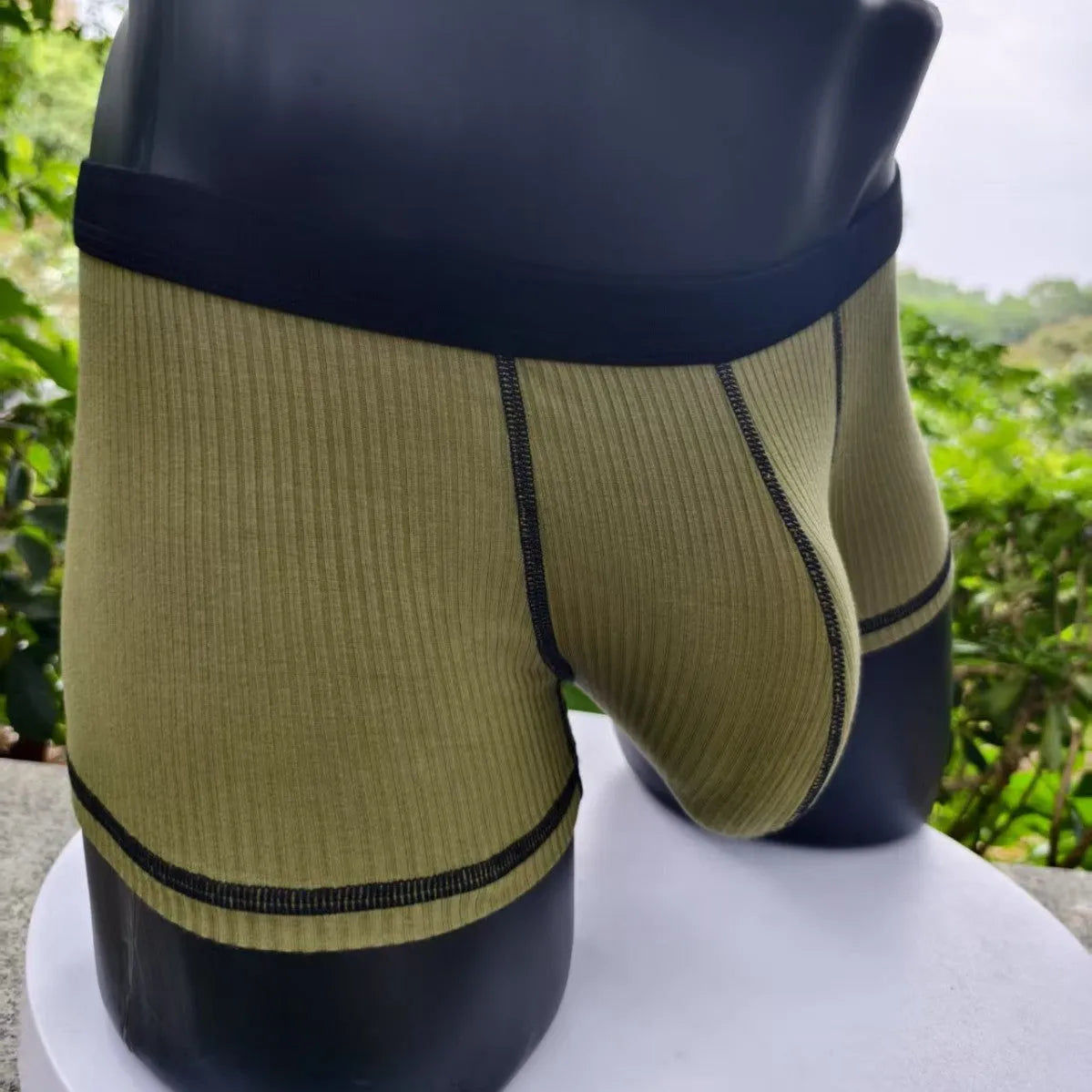 Men's solid colour boxer shorts on a white background, showing thin breathable fabric.