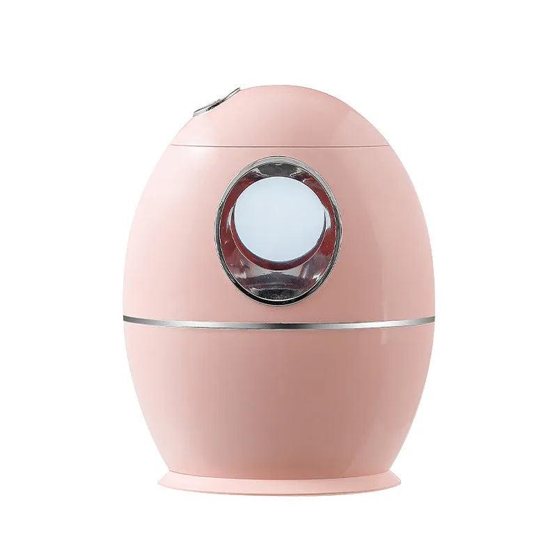 White round USB-powered aromatherapy spray humidifier on a table.
