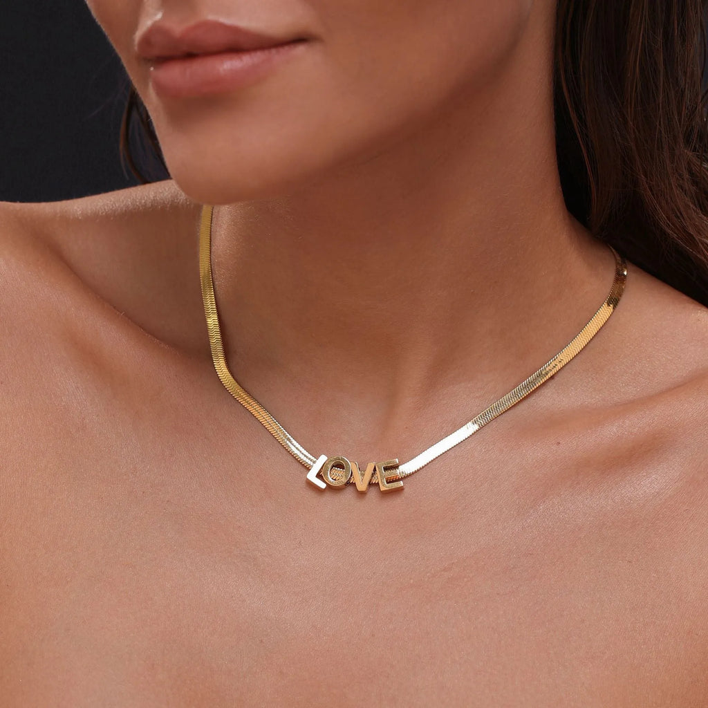 Gold or silver titanium steel necklace with a personalised letter, number, or heart pendant on a 40.5cm chain.