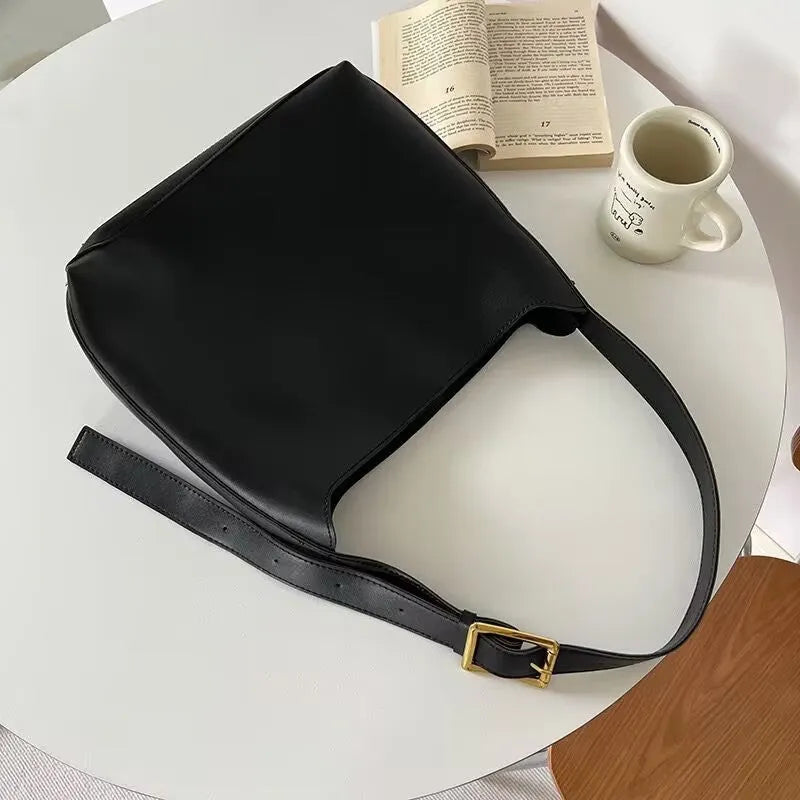 Women's soft PU leather shoulder bag with swing thread detailing in black or brown colour options
