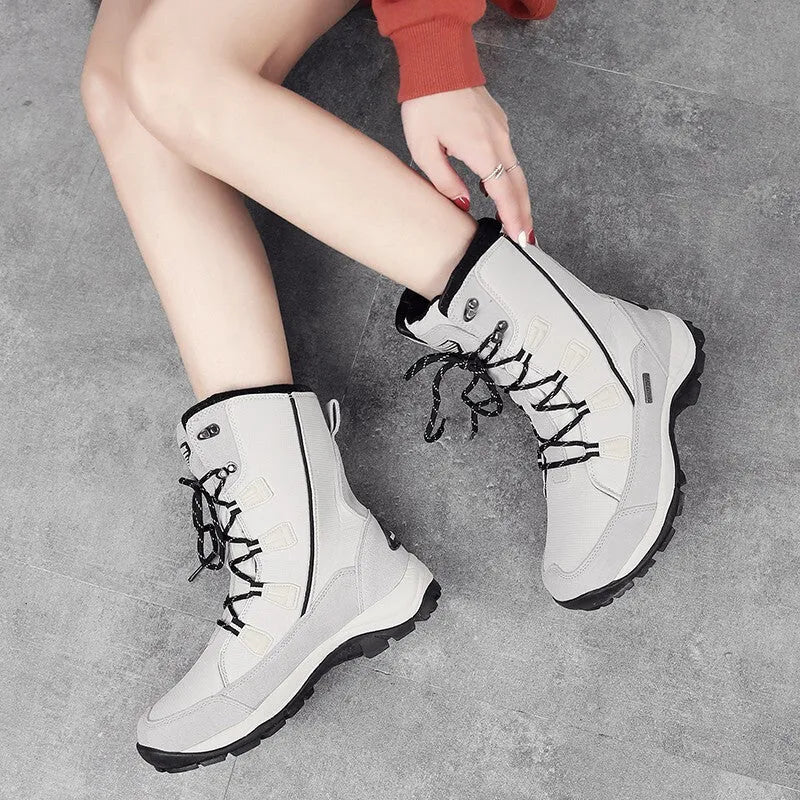 Women's black thermal snow boots with mid-calf height, round toe, and rubber sole.