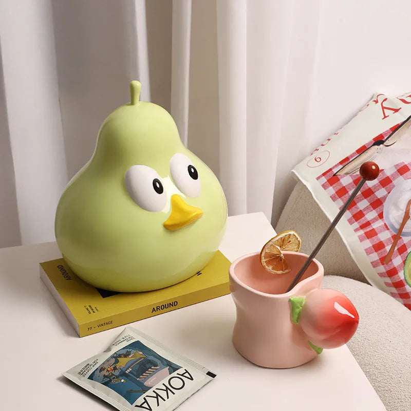 White ceramic pear-shaped tissue box in green or black colour on desktop