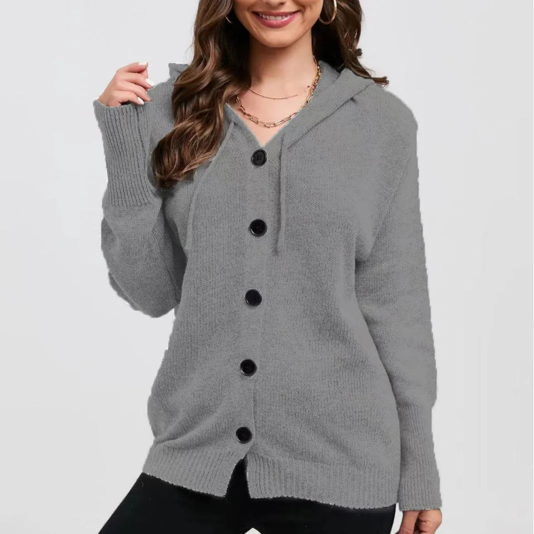Woman wearing a thick army green zip-up hooded cardigan sweater with a loose fit.