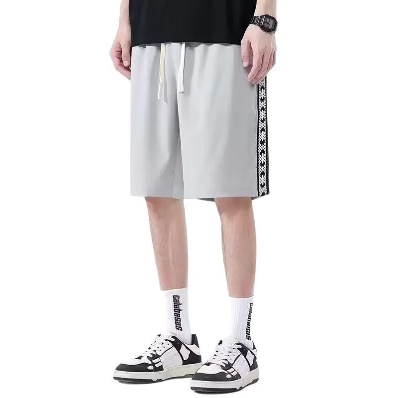 Men's loose-fit track pants in black polyester with micro-elastic fabric and sports styling