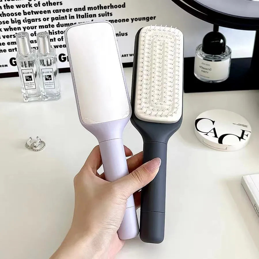 Roland purple and lunar rock grey self-cleaning hair brush with anti-static massage comb teeth.