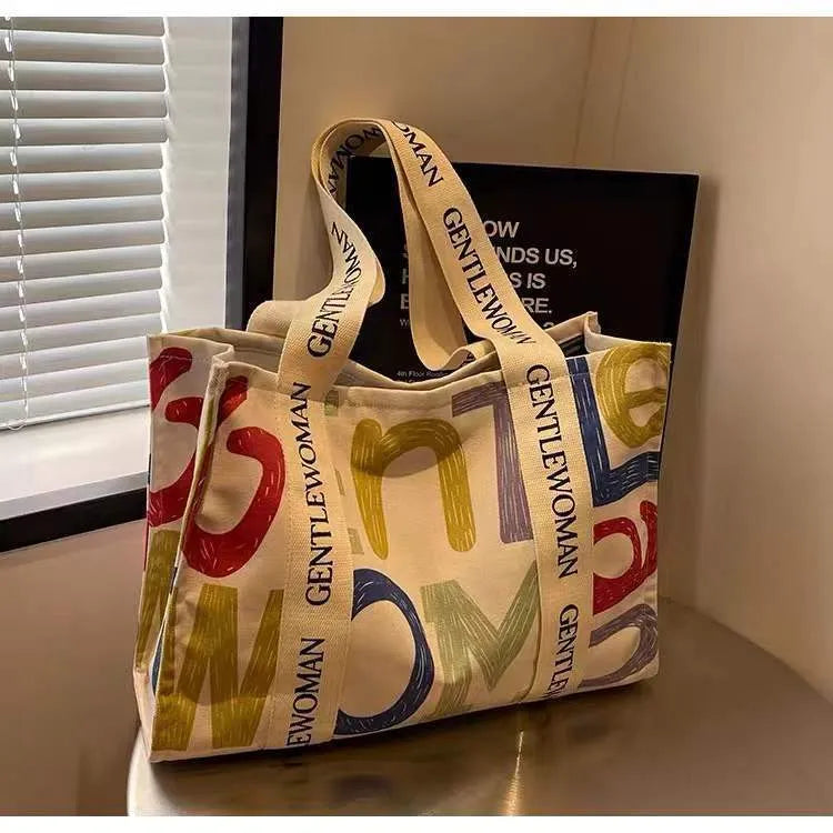 Women's large canvas tote bag with printed design options for travel and shopping.