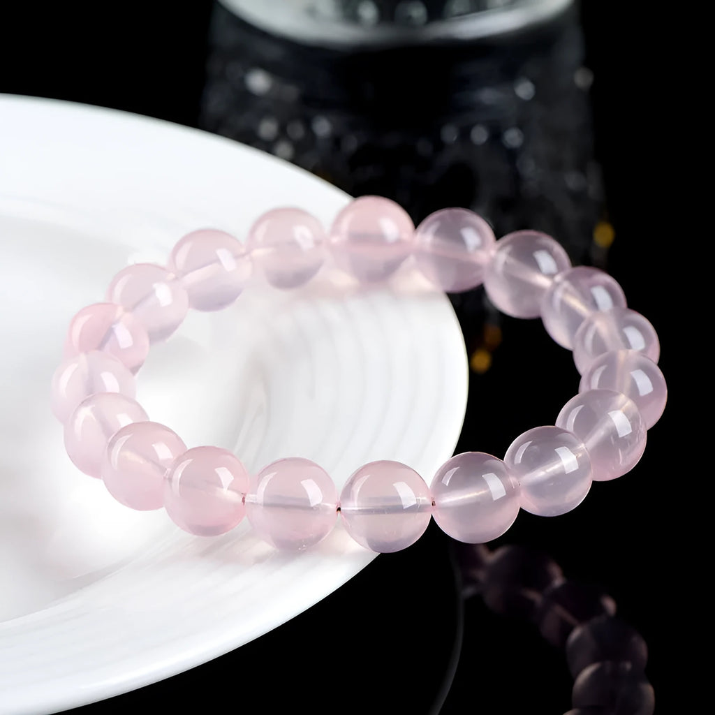 Natural pink starlight crystal round bead bracelet with polished finish in various sizes from 6mm to 22mm