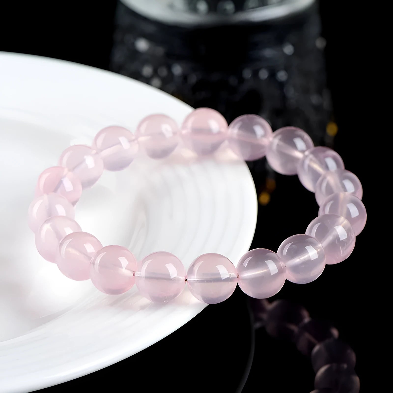 Natural pink starlight crystal round bead bracelet with polished finish in various sizes from 6mm to 22mm