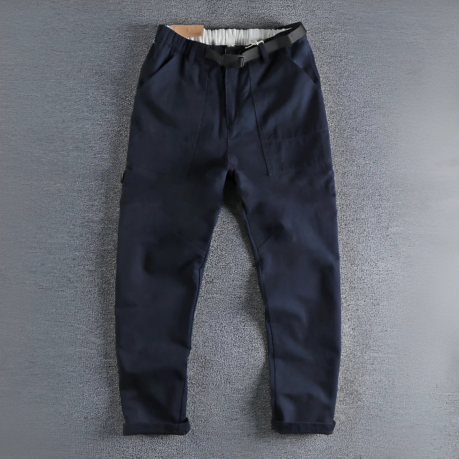 Men's khaki and dark blue cotton casual trousers with a mid-waist fit and zip fly.