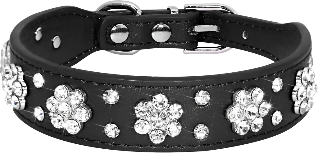 Close-up of a pink PU leather dog collar with silver rhinestone flowers and studs, showing the metal D-ring.