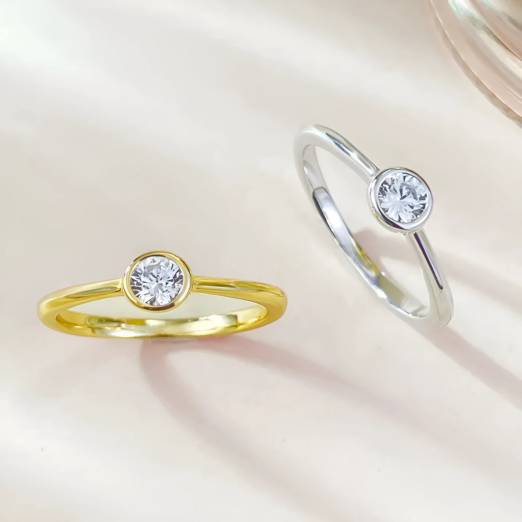 Minimalist crown-shaped silver ring with linear details, shown in gold and platinum electroplated finishes.