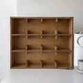 Square solid wood cup storage rack with birch finish and multiple square compartments for organising mugs.