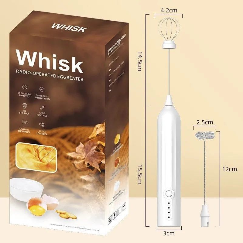 Compact black handheld USB rechargeable milk frother with stainless steel whisk on a kitchen counter.