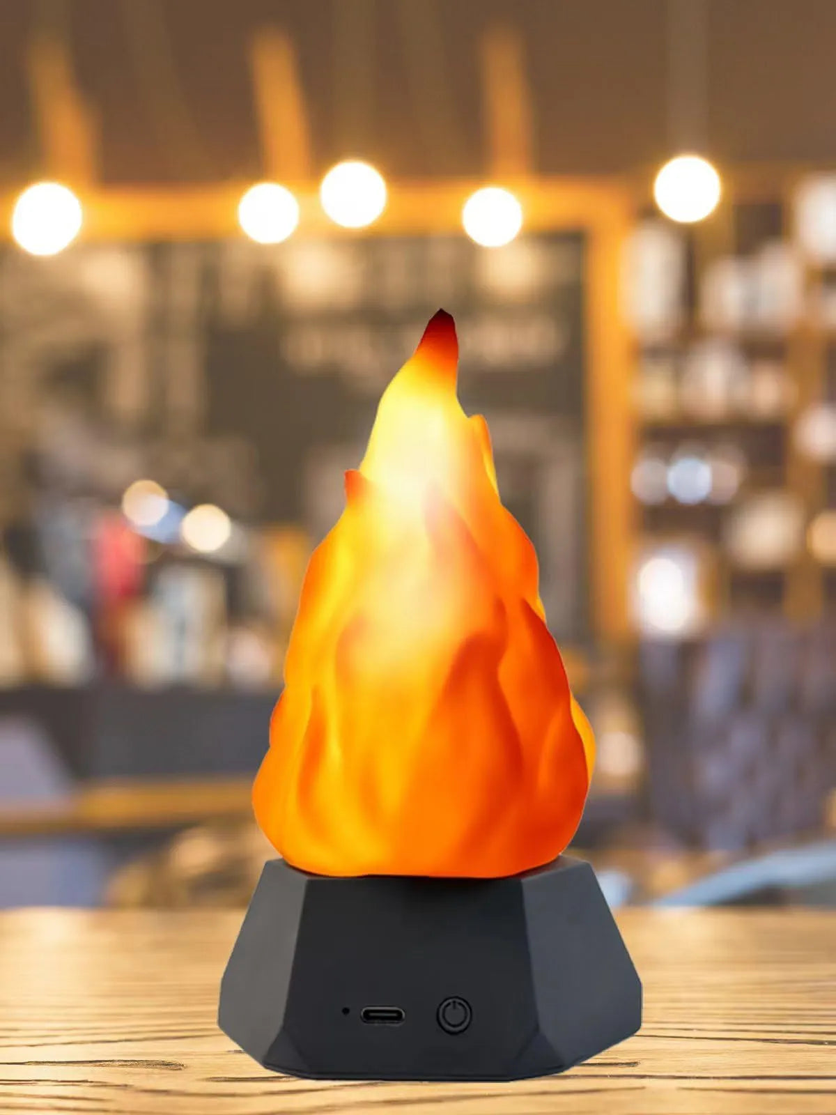 Flame-shaped outdoor decorative lights with black charging base on wooden surface