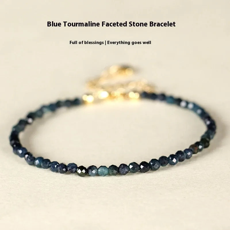 Blue tourmaline spacer bead bracelet with 3mm cut beads and blue gold accents