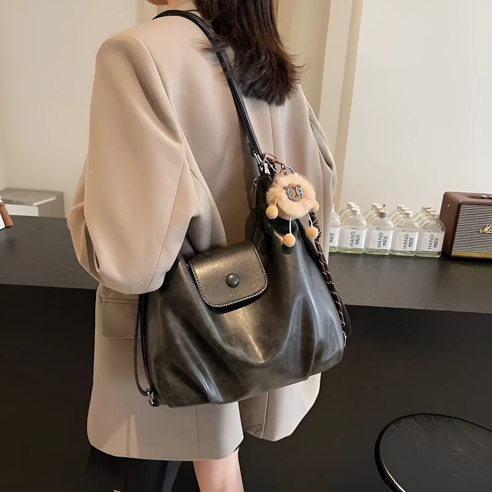Women's PU leather commuter shoulder bag in horizontal square shape with single strap and optional pendant