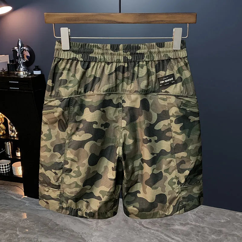 Man wearing loose-fit camouflage cargo shorts made from a cotton blend fabric.