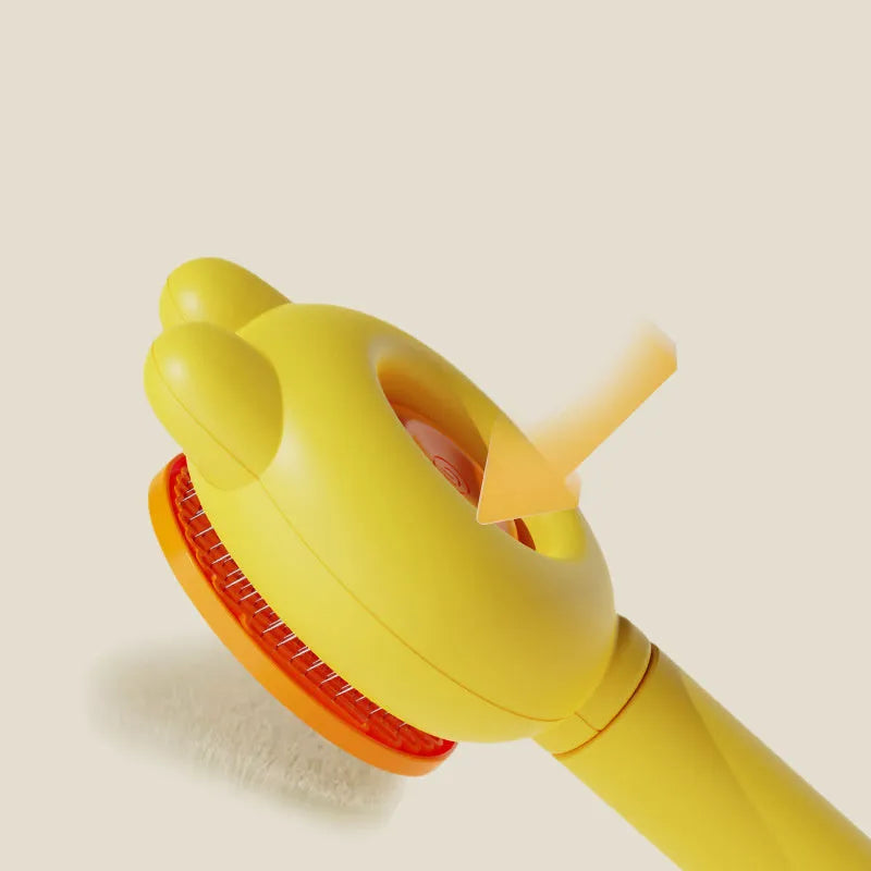 Green pet grooming brush with metal comb and release button on a non-slip handle