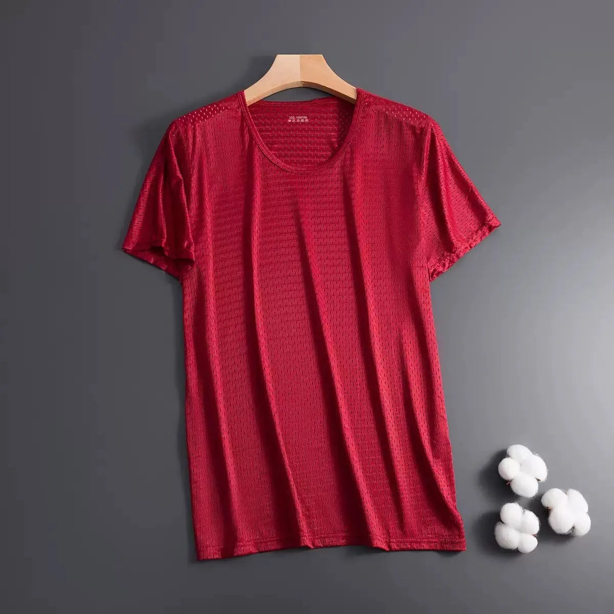 Man wearing a thin grey ice silk mesh short sleeve T-shirt with a crew neck.