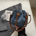 Blue one-shoulder cross body bucket messenger bag with an external sandwich pocket.