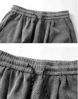 Straight-leg fleece-lined trousers in light grey on a hanger, showing elastic waistband.