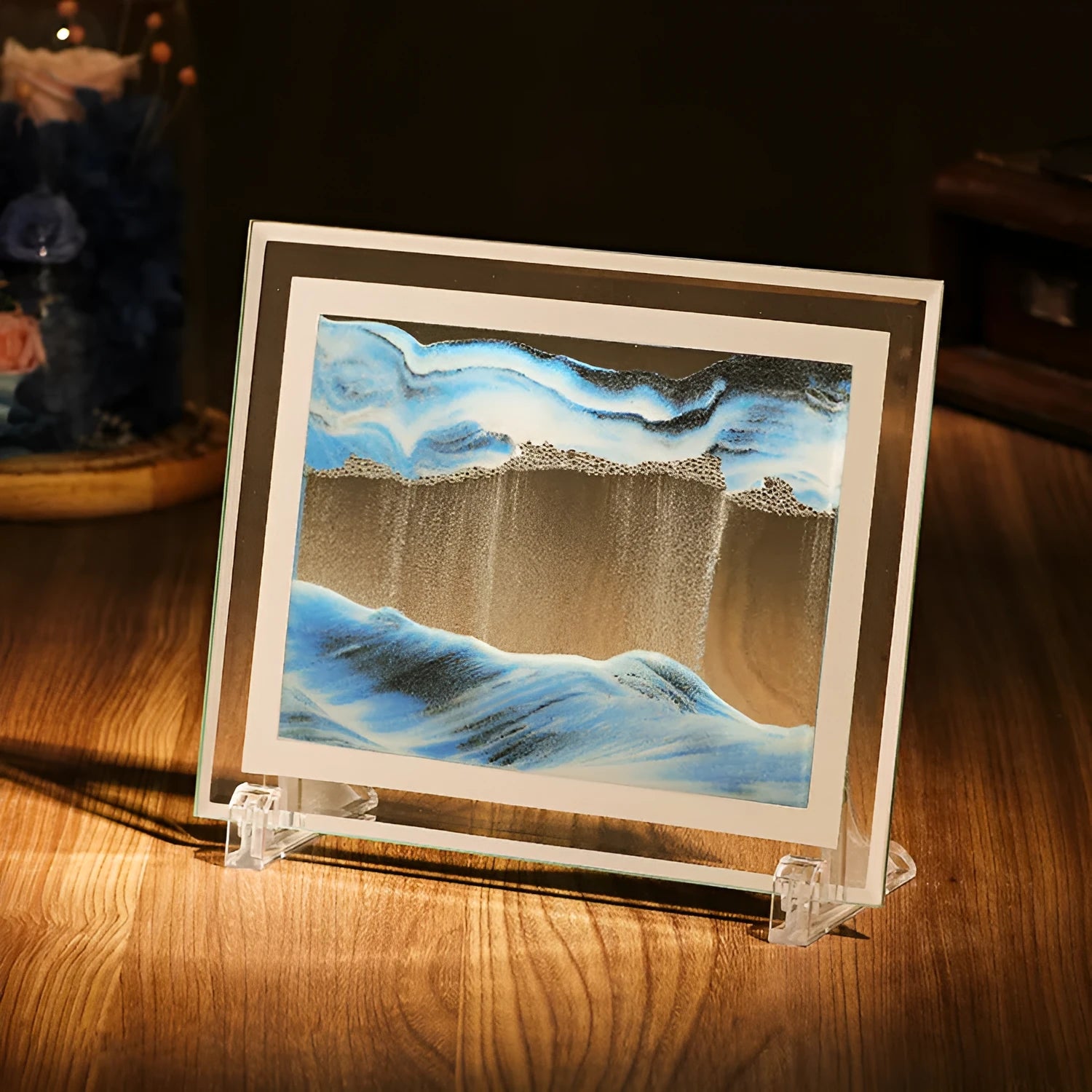 Glass quicksand painting ornament with geometric shape showing landscape sand art in black and white green colours.