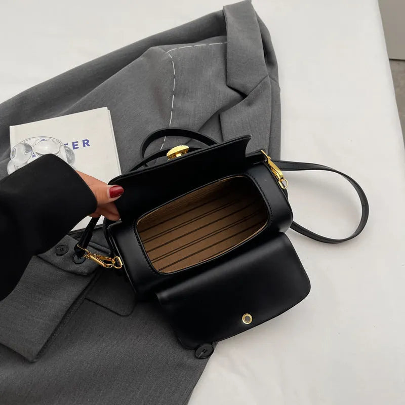 Women's personalised PU messenger bag with letter detailing in beige, shown from the front.
