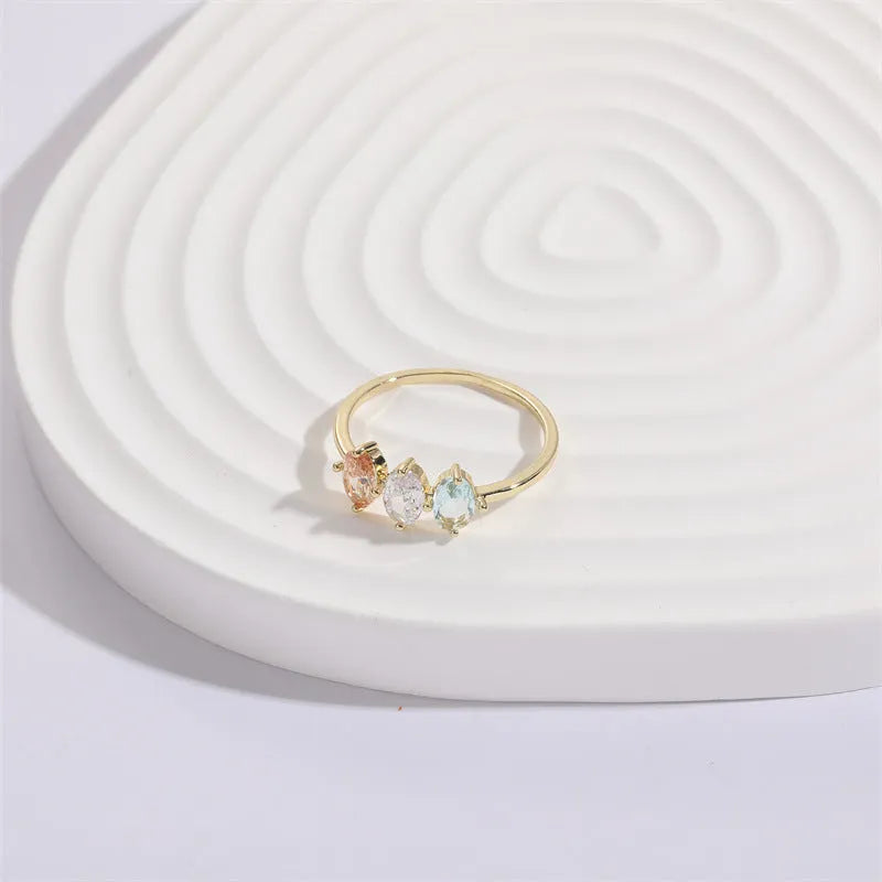 Geometric triangle women's ring with tricolor zircon horse eye design in electroplated gold.