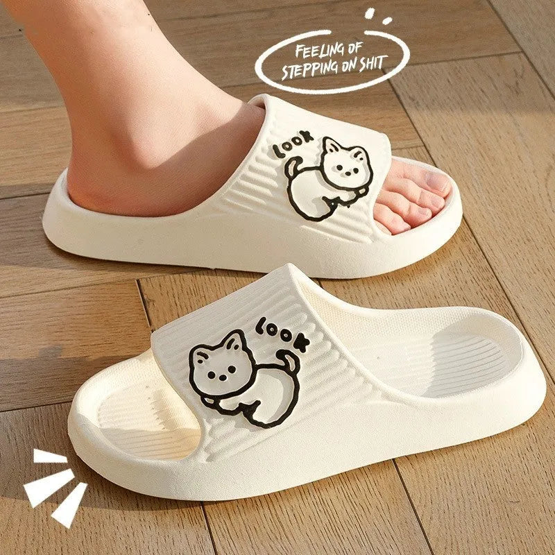 Green EVA platform flip flop slippers with a raised cat design on the upper.