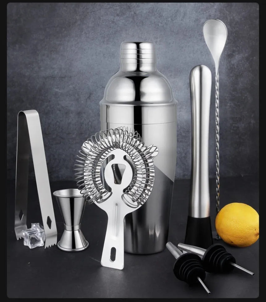23-piece European style stainless steel cocktail set with shaker, strainer, and bar tools on a table.