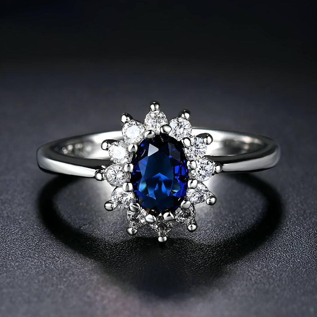 Women's copper floral ring with inlaid zirconium detail in green, blue, or red.