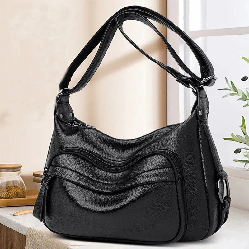 Women's blue soft PU crossbody bag showing interior phone and document compartments with zipper closure