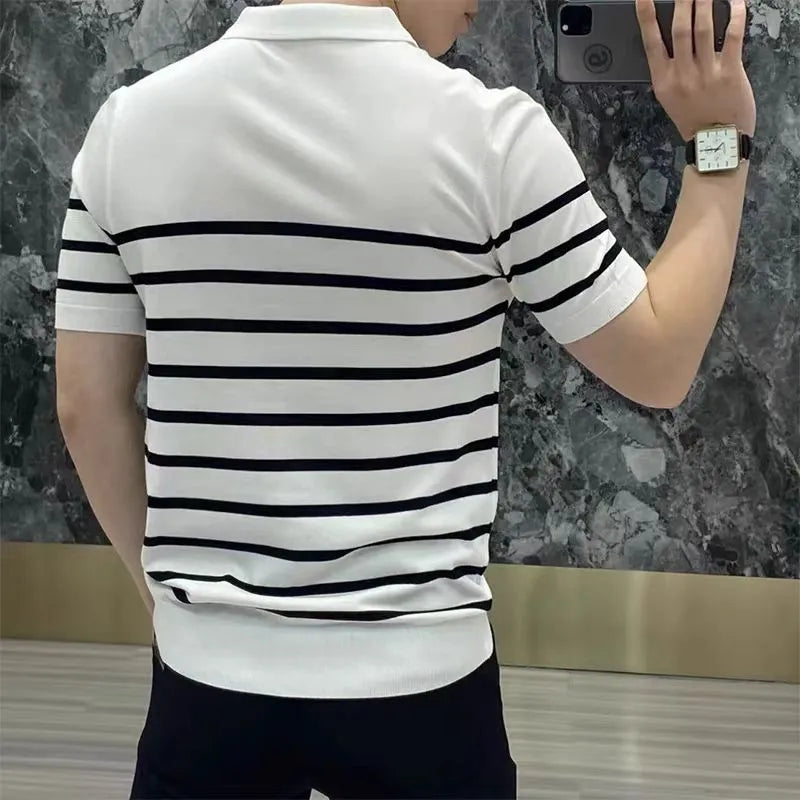 Man wearing a black and white striped knitted t-shirt with a lapel collar, showcasing a smart-casual look.