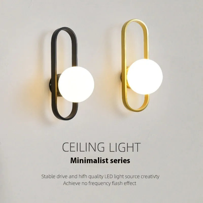 Minimalist wall lamp with glass shade and iron body in black or gold colour