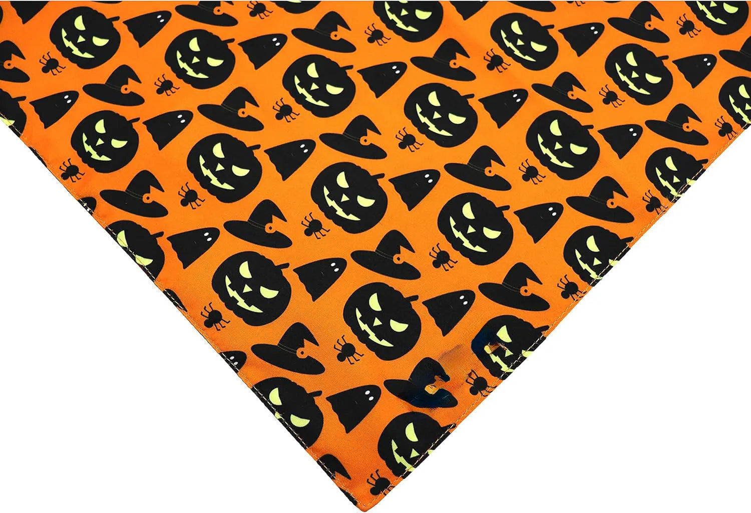Black and orange reversible Halloween dog bandana with pumpkin and spider web patterns lying flat.
