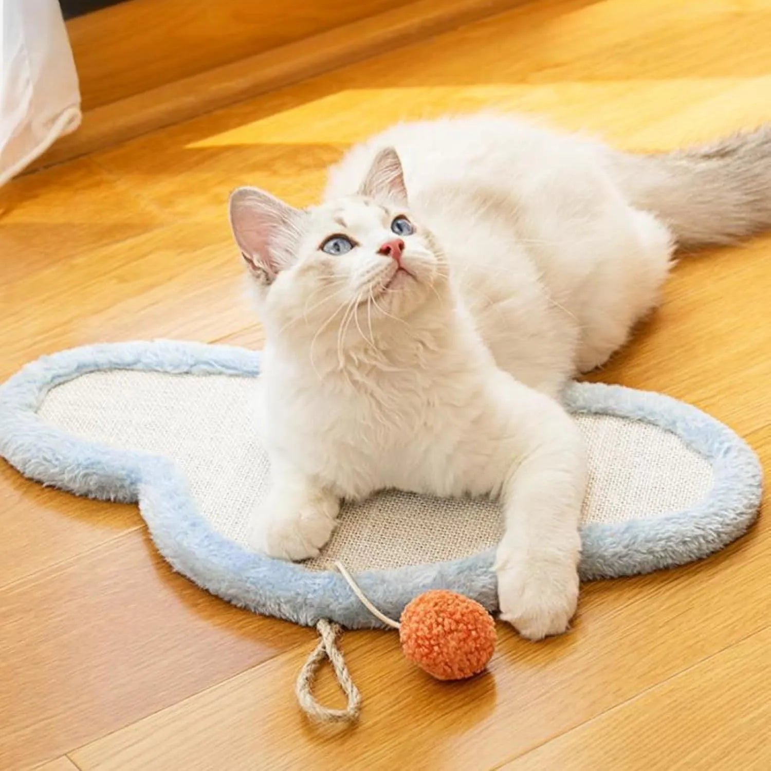 White cat scratching mat with sleeping cat cartoon design, made from natural sisal fibre.