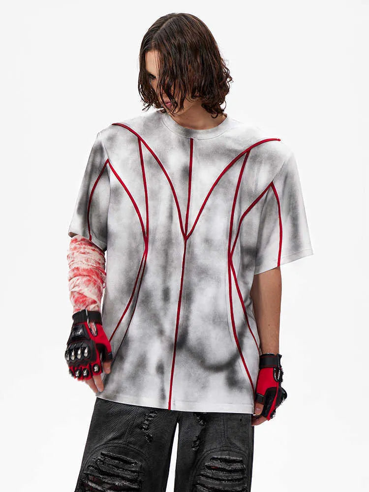 Short sleeve t-shirt with padded shoulders and three-dimensional line patchwork design on a round neck.