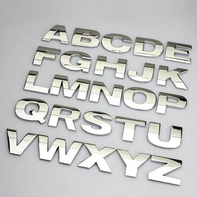 Close-up of a black metal 3D letter car sticker made from zinc alloy, showing its raised profile.