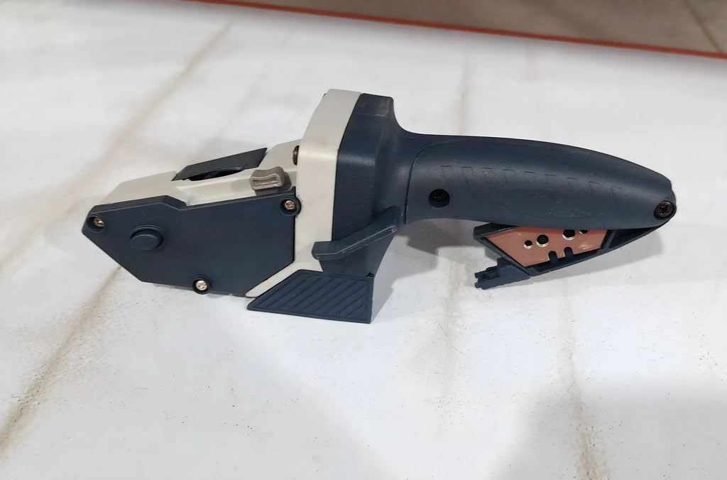 Blue multifunctional woodworking cutter with one-press lock and measuring scale for board materials.