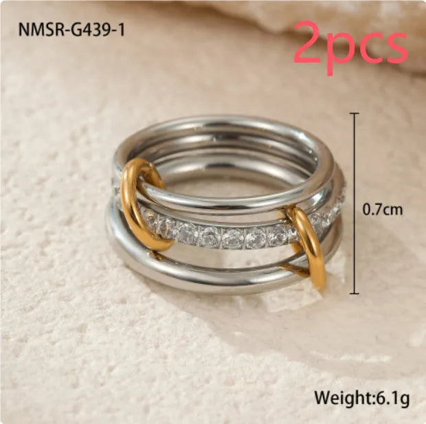 Stacked gold plated stainless steel ring set showing exaggerated design on a model's hand.