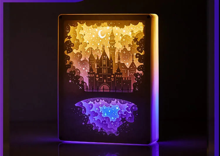Modern bedside USB night light with paper carving design and remote control on a table.