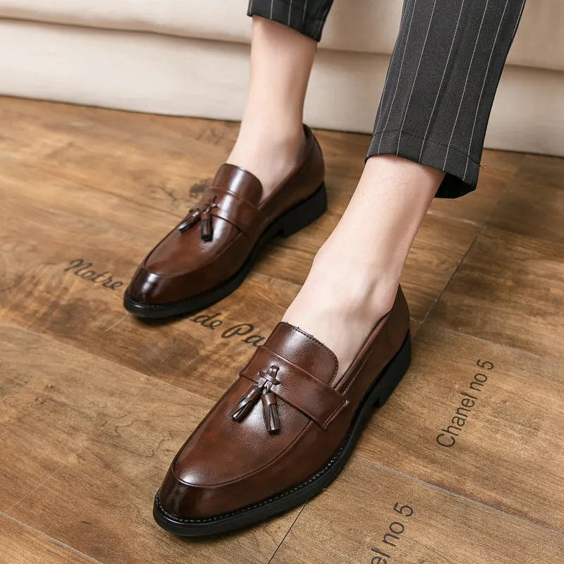 Men's black and brown business casual slip-on shoes with tassel detail and rubber soles