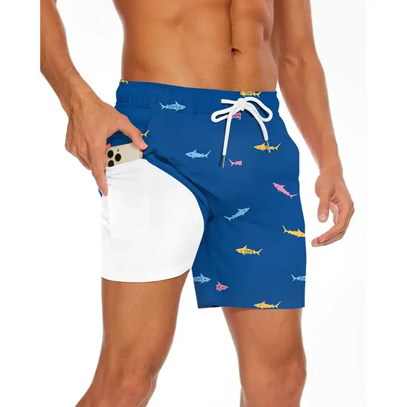 Man wearing loose light blue polyester beach pants on sand, showing plus size fit.